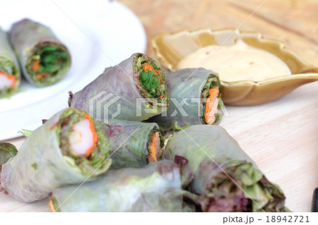 Vegetable salad wrapped into spring rolls Vegetable salad wrapped into spring rolls 18942721