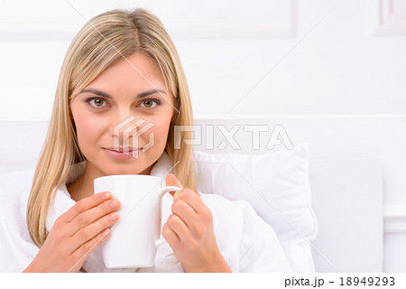 Young woman enjoying hot drink. 18949293