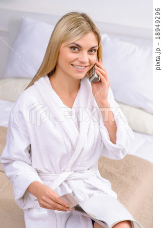 Young woman ordering from catalogue.  18949296