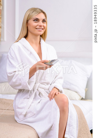 Young attractive woman using remote control. 18949335