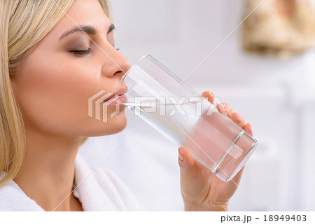Young lady drinking water.  18949403