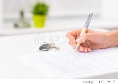 Hotel form and room keys resting on the counter. 18949417