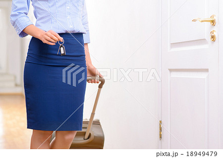 Female traveller is standing in the hallway. Female traveller is standing in the hallway. 18949479