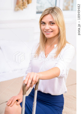 Girl sitting in her hotel suite.  18949482