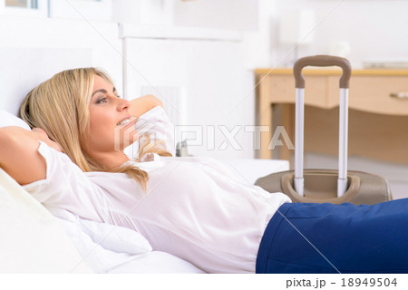 Female tourist resting in her bed.  18949504