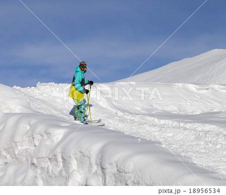 Skier on off-piste slope in sun day 18956534