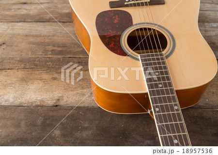 Close up acoustic guitar on old wood panel 18957536