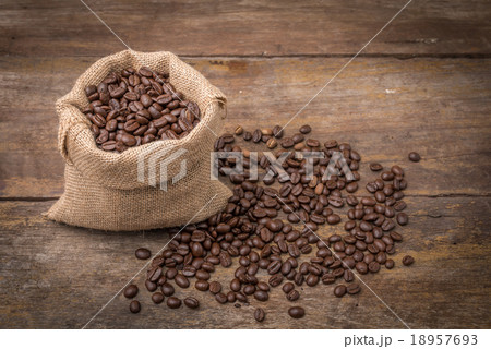 Roasted coffee beans in burlap sack bag Roasted coffee beans in burlap sack bag 18957693