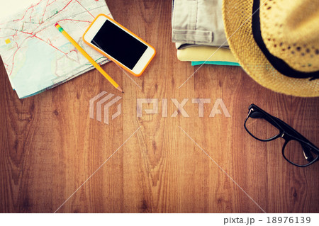 close up of summer clothes and travel map on table close up of summer clothes and travel map on table 18976139
