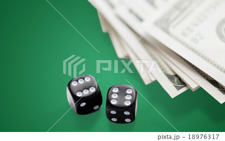 close up of black dice and dollar cash money close up of black dice and dollar cash money 18976317