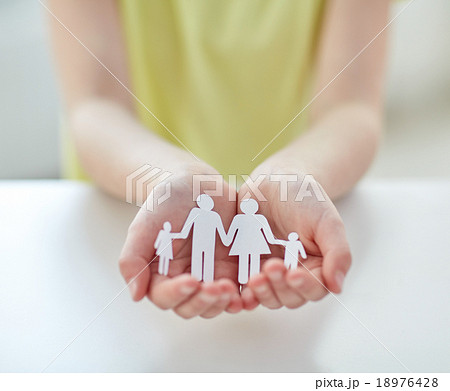 close up of child hands with paper family cutout close up of child hands with paper family cutout 18976428