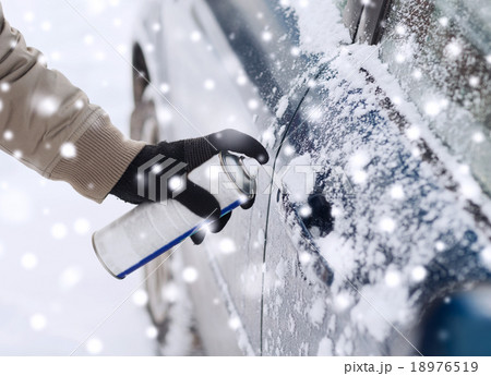 closeup of man hand with lock door de-icer 18976519