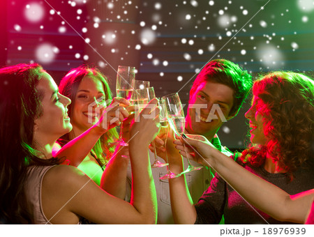 smiling friends with glasses of champagne in club smiling friends with glasses of champagne in club 18976939
