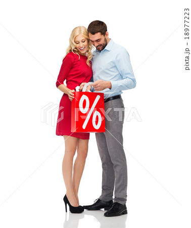 happy couple looking into red shopping bag happy couple looking into red shopping bag 18977223