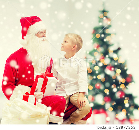 smiling little boy with santa claus and gifts 18977555