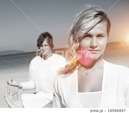 People performing yoga on the beach 18988897