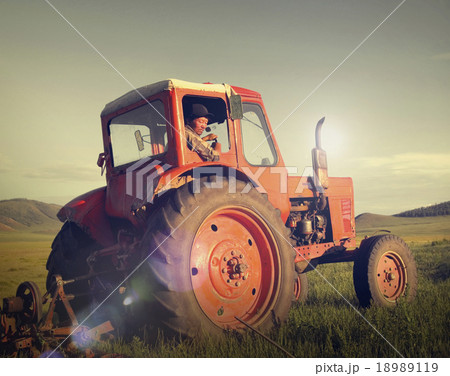 Mongolian Farmer Driving Tractor Field Agicultural Concept Mongolian Farmer Driving Tractor Field Agicultural Concept 18989119