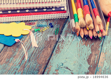 Office or school supplies on wooden board. Office or school supplies on wooden board. 18994636