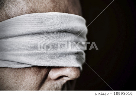 young man with a blindfold in his eyes 18995016