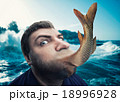 Man eating fish 18996928
