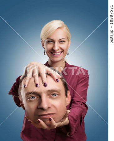 Woman with man's head in her hand 18997581