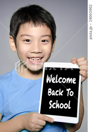 asian boy hold tablet With Back to School concept asian boy hold tablet With Back to School concept 19003902
