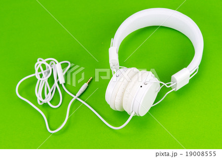 White headphone on green background White headphone on green background 19008555