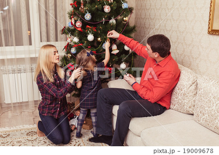 Family near Christmas Tree 19009678