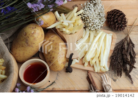 French fries and fresh sliced potatoes  French fries and fresh sliced potatoes  19014142