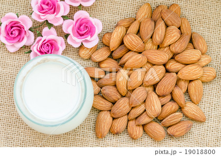 Almond and milk in glass with flower. 19018800