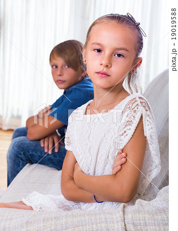 Offended little girl and teenager indoors. Offended little girl and teenager indoors. 19019588