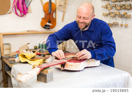 Guitar-maker at workshop. Guitar-maker at workshop. 19019885