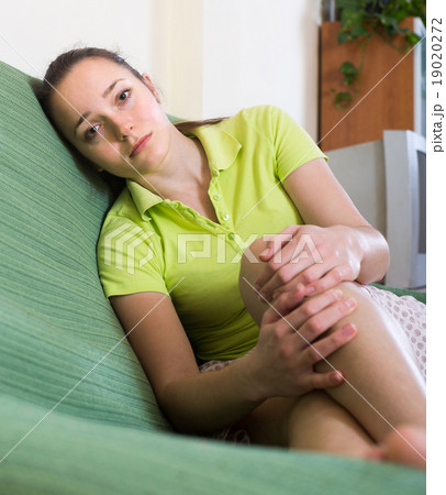 Sad woman sitting at home Sad woman sitting at home 19020272