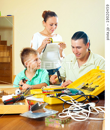 Father and son spend their free time with working tools at home Father and son spend their free time with working tools at home 19020459