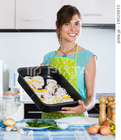 Woman preparing merluccid hake Woman preparing merluccid hake 19020655