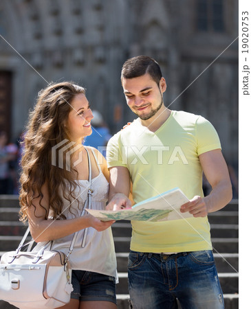 Two friends with map in the street Two friends with map in the street 19020753