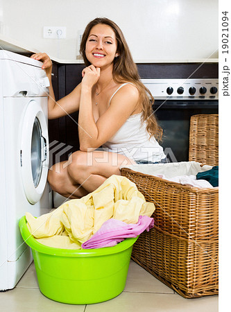 nice girl washing clothes in washer nice girl washing clothes in washer 19021094