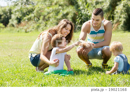 Family of four in sunny park Family of four in sunny park 19021168