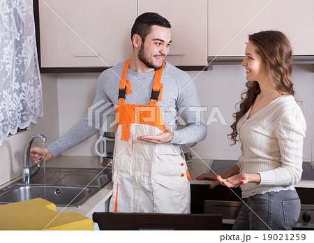 Repairman and housewife at kitchen Repairman and housewife at kitchen 19021259