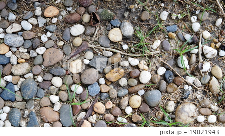 Colorful pebbles on sand ground Colorful pebbles on sand ground 19021943