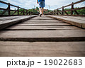 Man walking on a wooden bridge 19022683