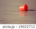 Orange toy bucket on the beach 19022712