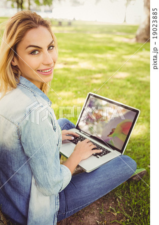 Portrait of smiling woman using laptop Portrait of smiling woman using laptop 19023885