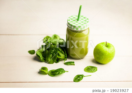 High angle view of juice jar with green apple and basil High angle view of juice jar with green apple and basil 19023927