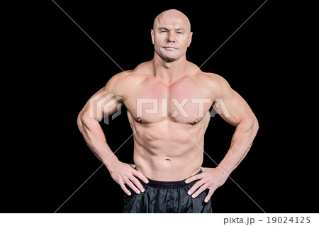 Portrait of bald man with hand on hip 19024125