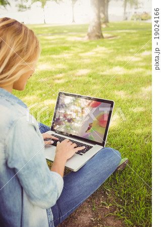 Woman using laptop while sitting in park Woman using laptop while sitting in park 19024166