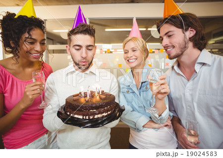 Businessman blowing birthday candles Businessman blowing birthday candles 19024583