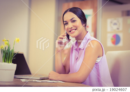 Confident businesswoman using phone Confident businesswoman using phone 19024607