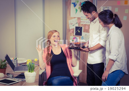 Surprised woman seeing birthday cake Surprised woman seeing birthday cake 19025294