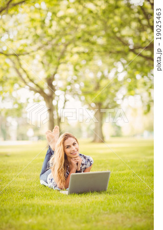 Portrait of smiling woman with hand on chin at park Portrait of smiling woman with hand on chin at park 19025463